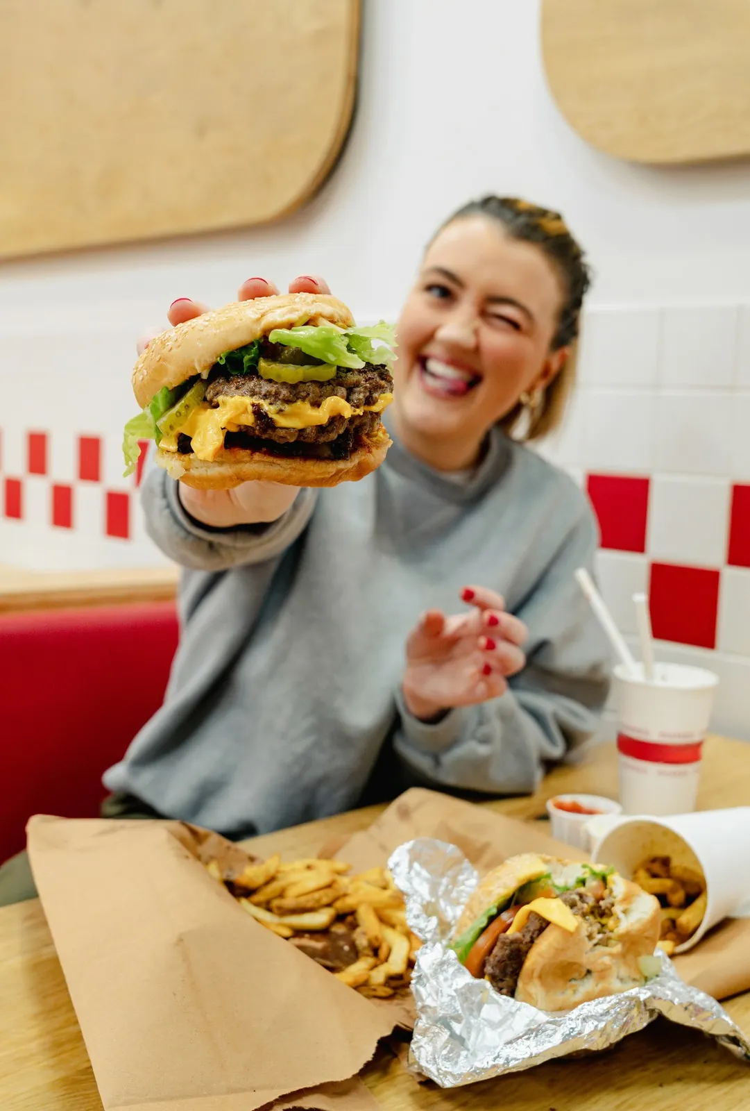 Guest holding up a burger